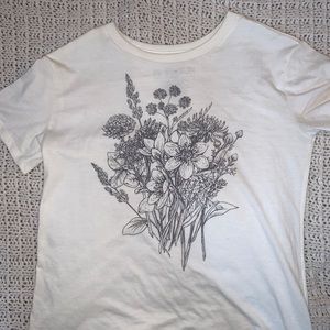 A white tee shirt with flowers on it